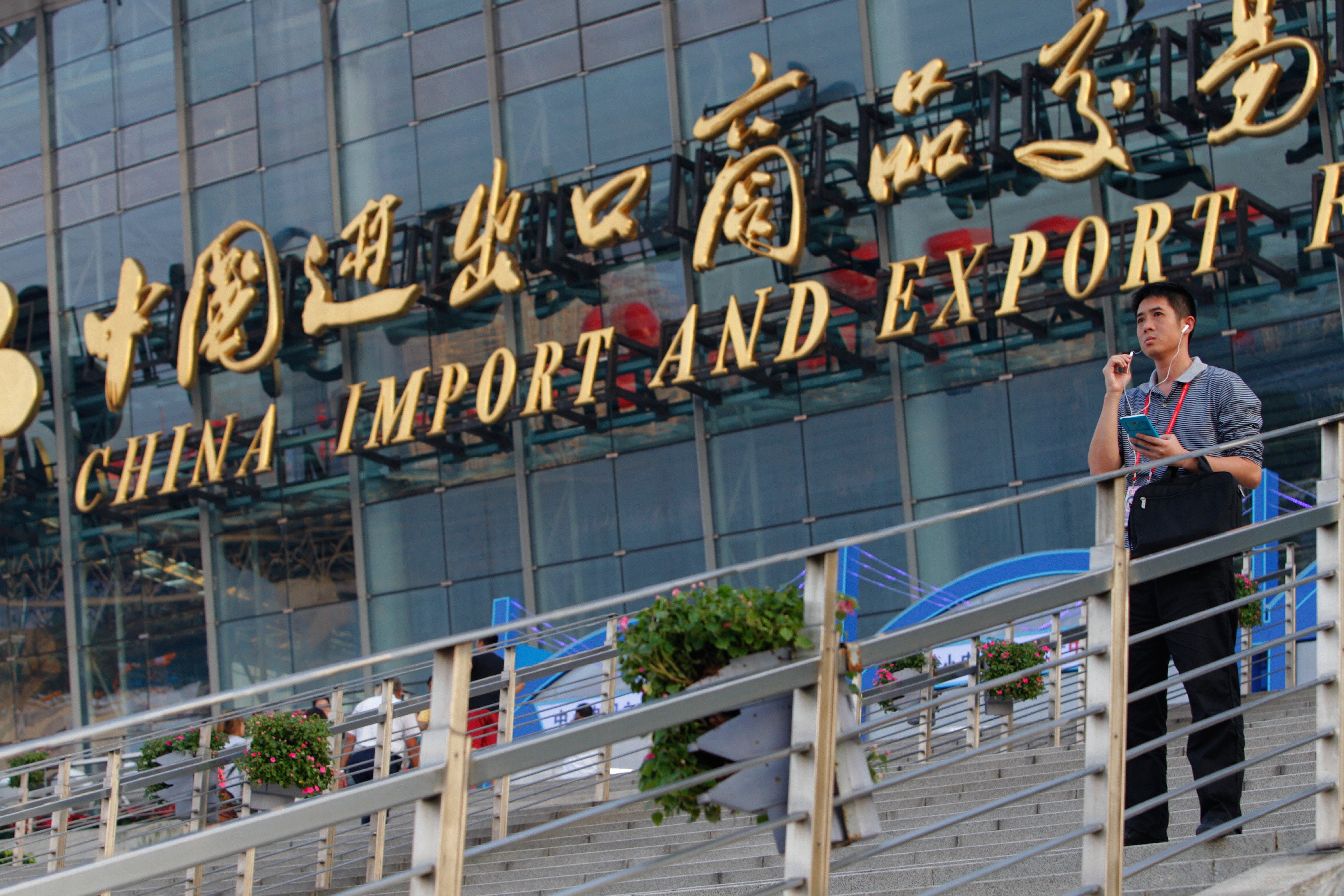 Image of man on steps in front of China Import and Export Fair in Guangzhou, China
