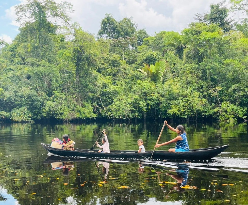 Image of indigenous Warao in a canoe on the Kaituma River in Guyana