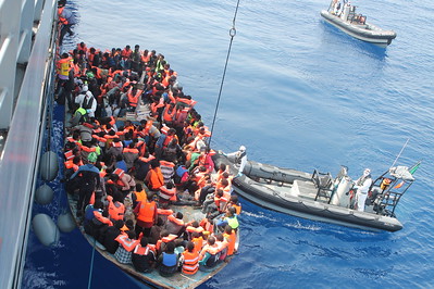 Migrants aboard a rubber vessel are rescued in the Mediterranean