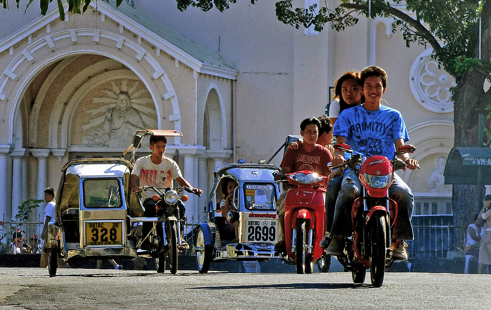 Young people ride motorcycles in Batac, Philippines.