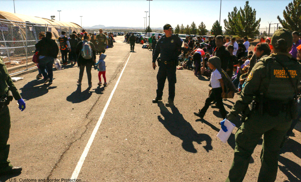 Border Patrol Officers and Migrants at U.S.-Mexico Border