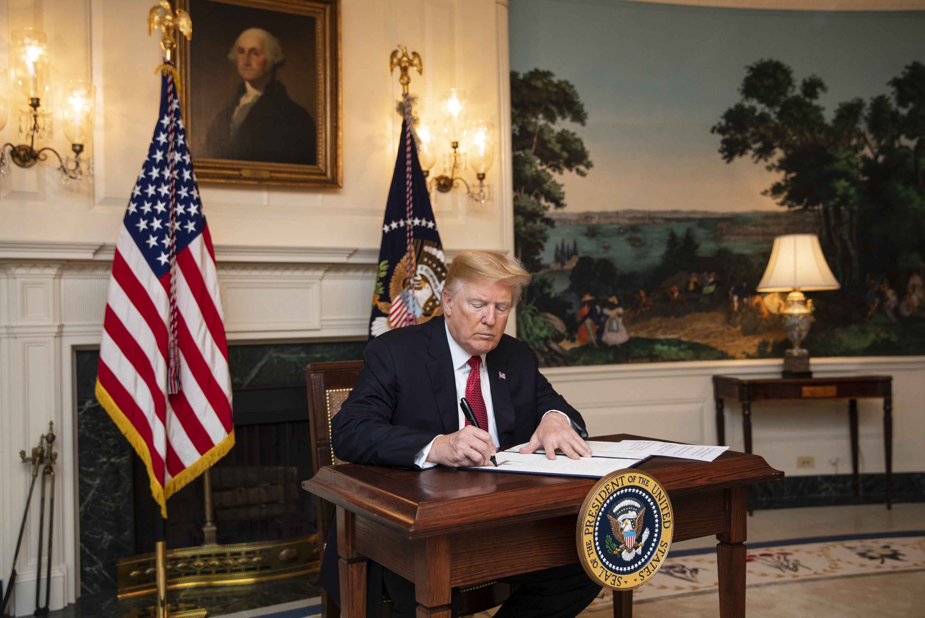 President Trump signs an immigration proclamation at the White House