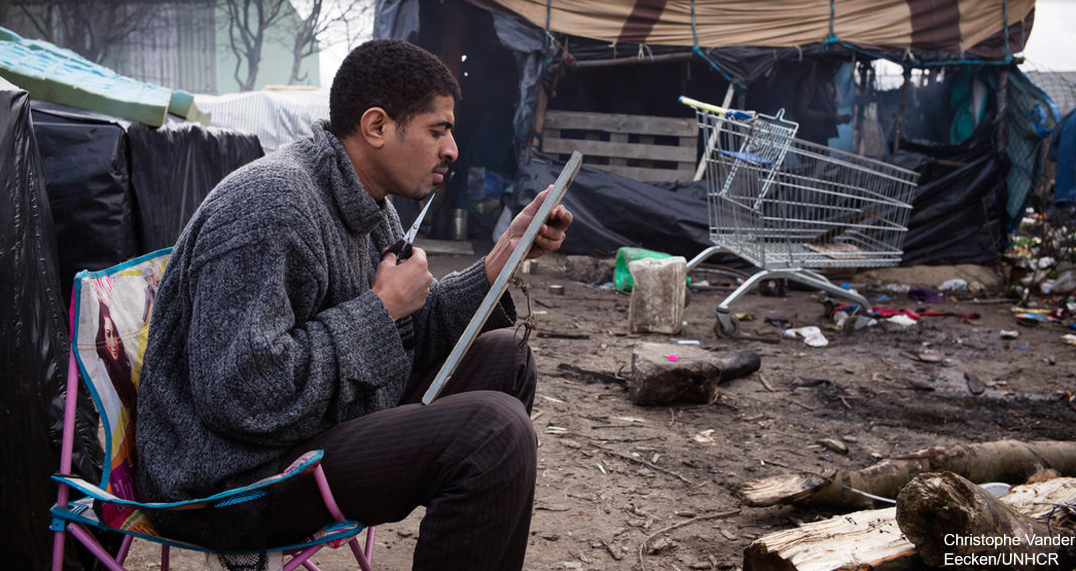 Eritrean man trimming beard refugee camp
