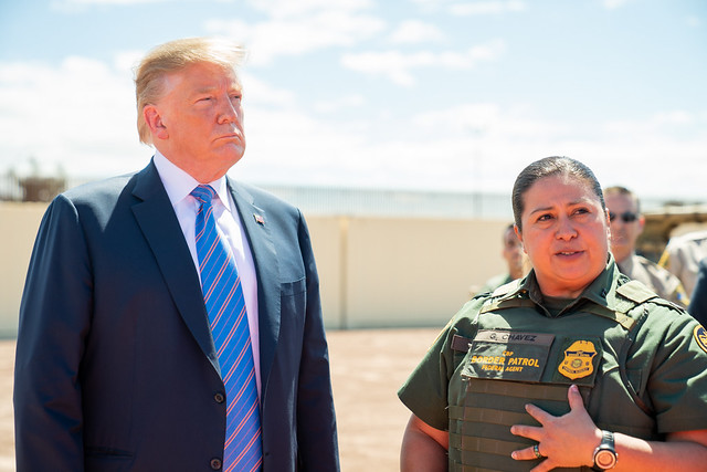 President Trump and a Customs and Border Patrol officer stand together