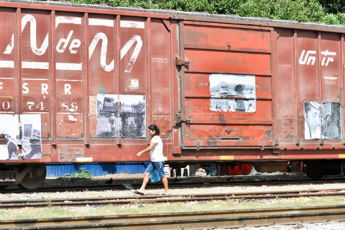 A woman walks alongside a train in Mexico.