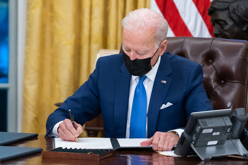 President Joe Biden signs executive orders on immigration in the White House.