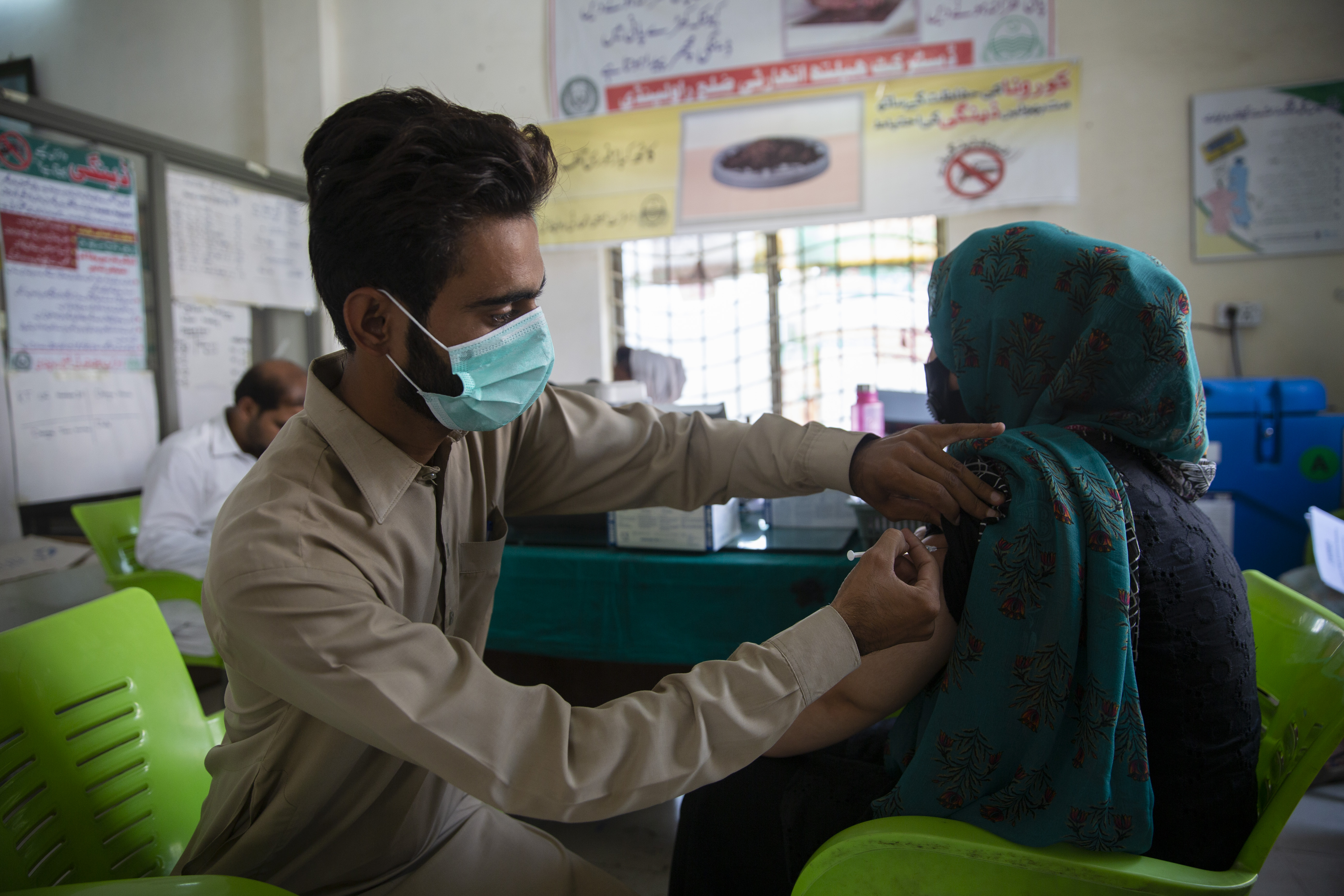 An Afghan refugee receives a COVID-19 vaccination in Pakistan.