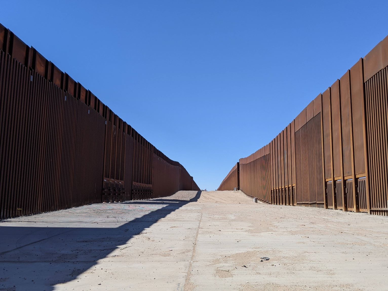 A double border wall leads to a boat launch in Yuma, Arizona.
