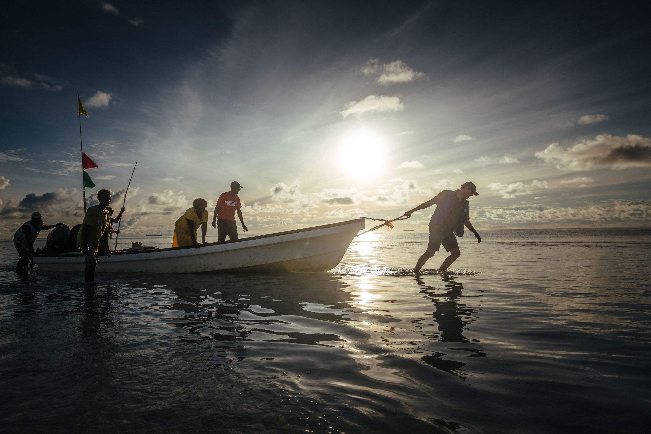 A man pulls a boat on the low-lying Carteret Islands in Papua New Guinea