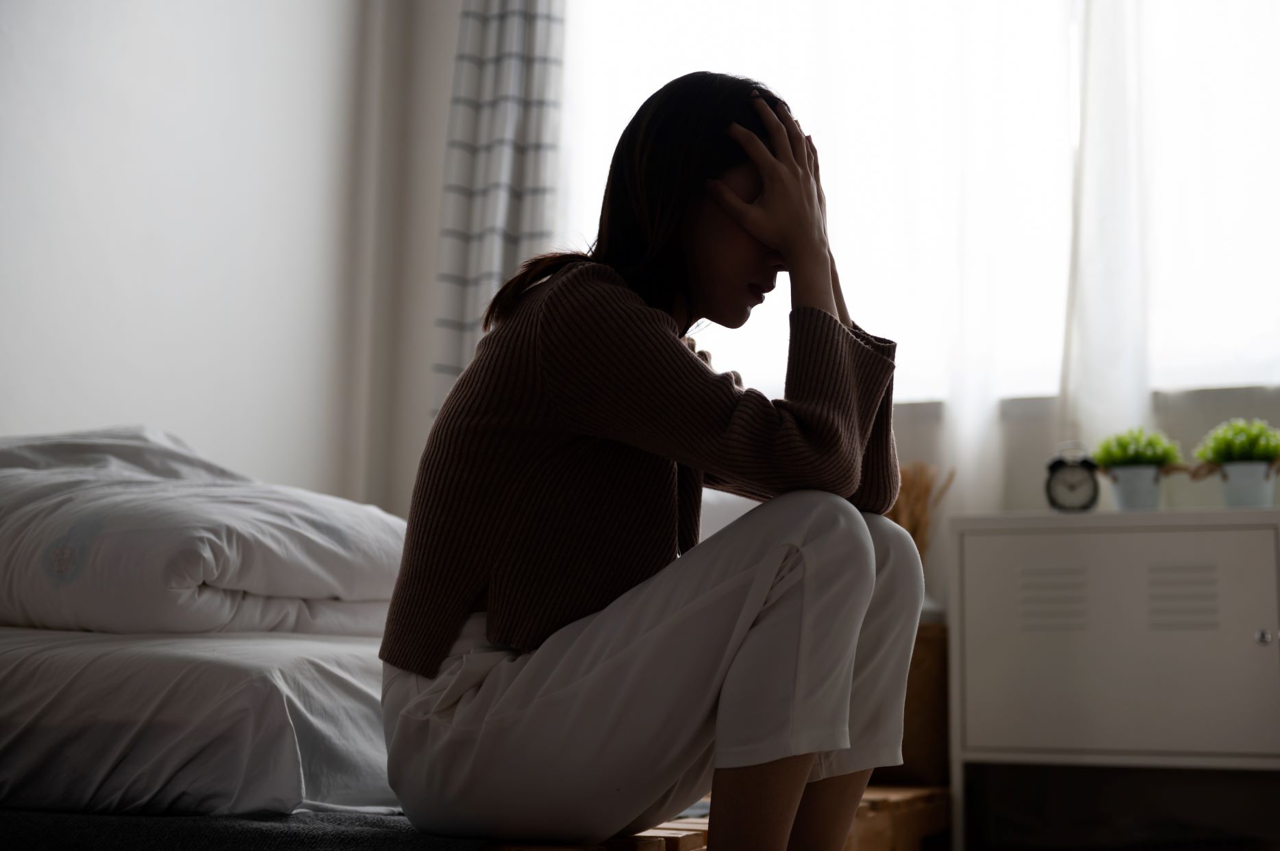 A woman crying in her room.