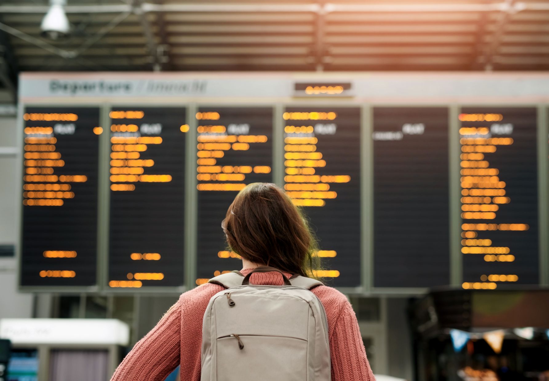 A woman at an airport looks at flight information