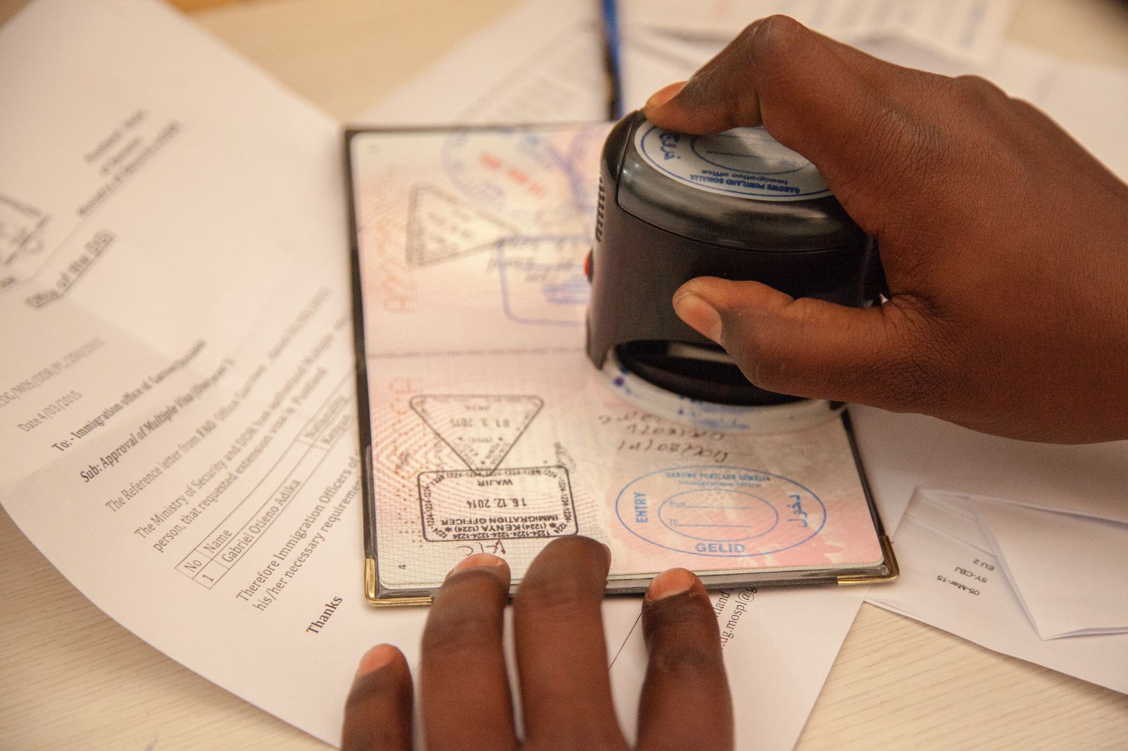 A travel document being stamped in Somalia.