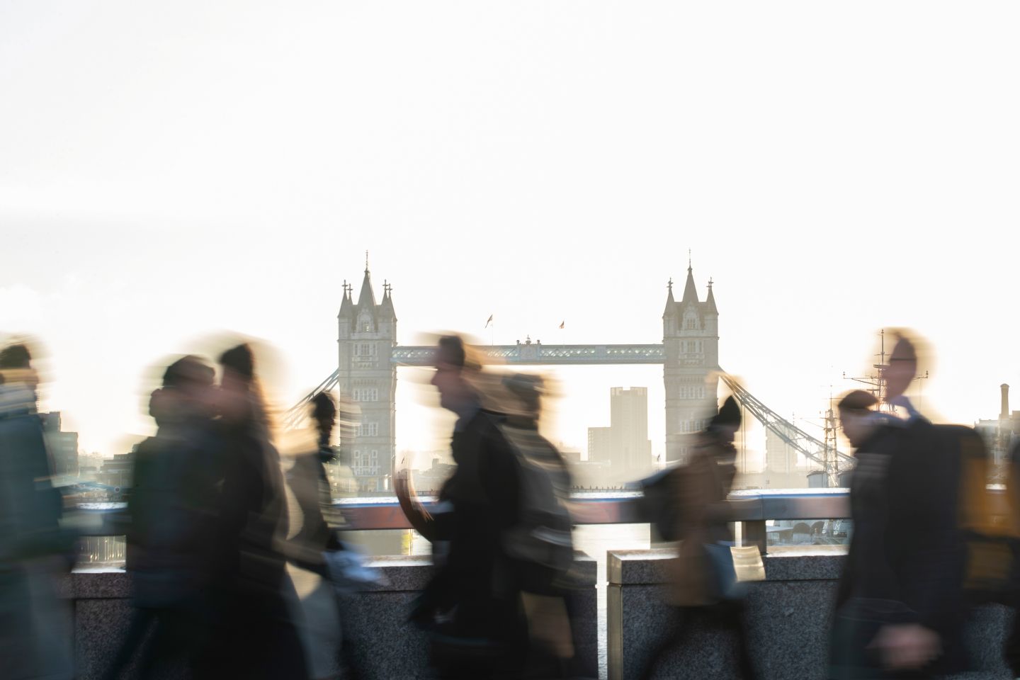 People walk in front of Tower Bridge in London.