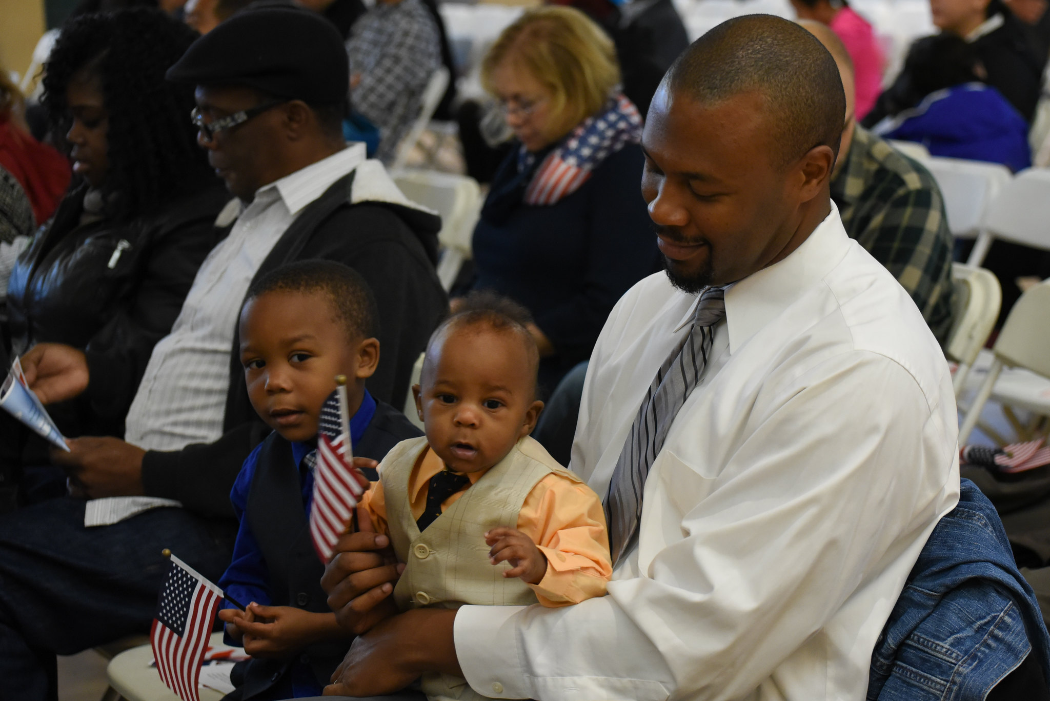 A man and child at a naturalization ceremony outside Washington, DC.