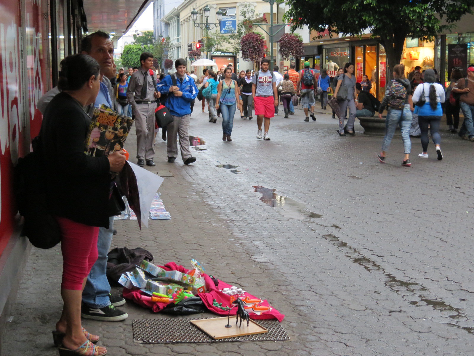 Merchants sell items on a busy street in San José, Costa Rica.