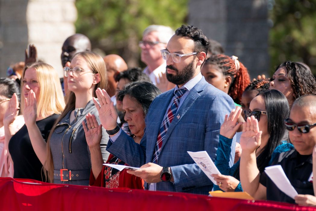 Immigrants take the oath of allegiance during a naturalization ceremony.