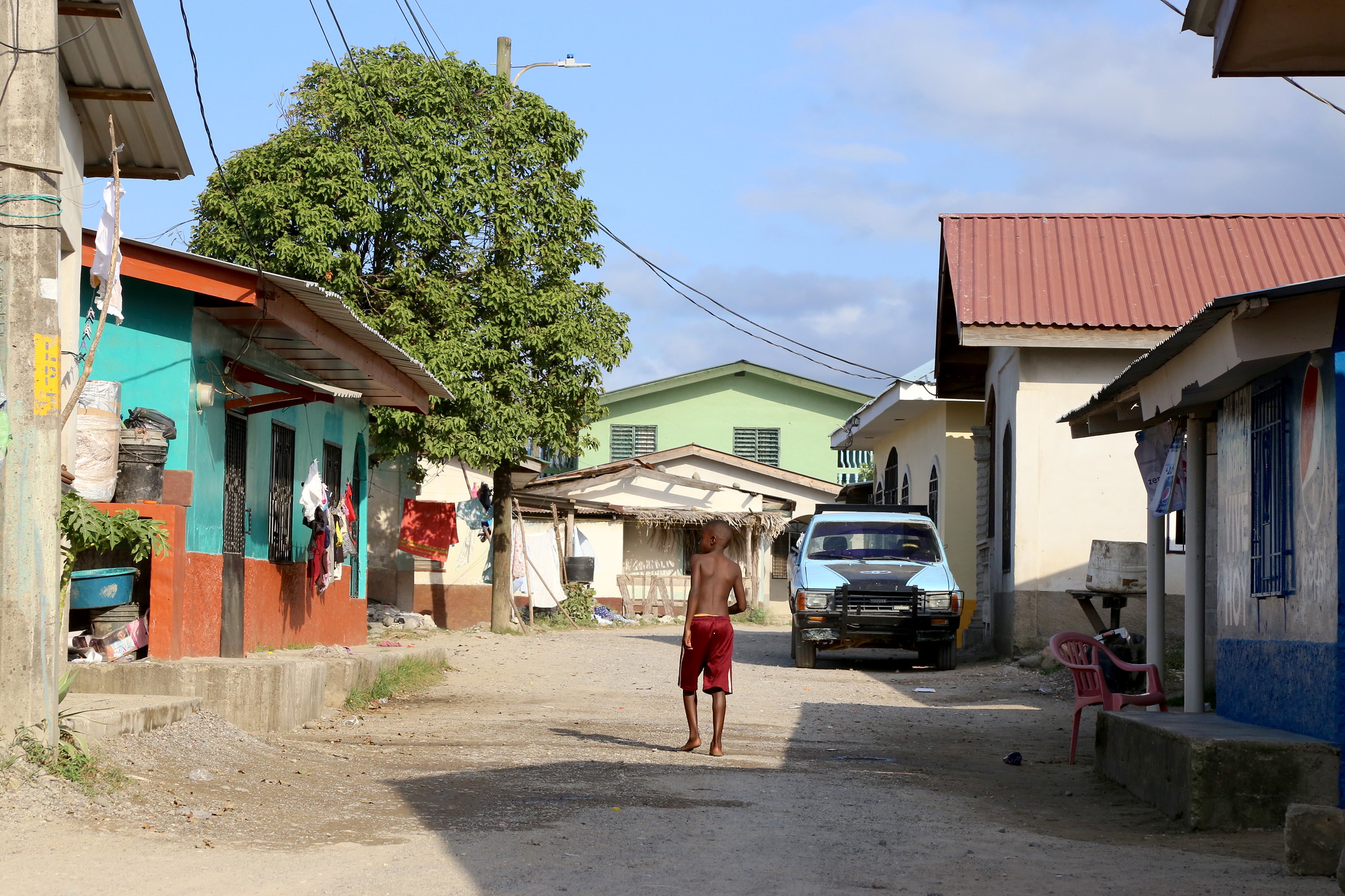 A boy walks through a coastal village in Honduras.