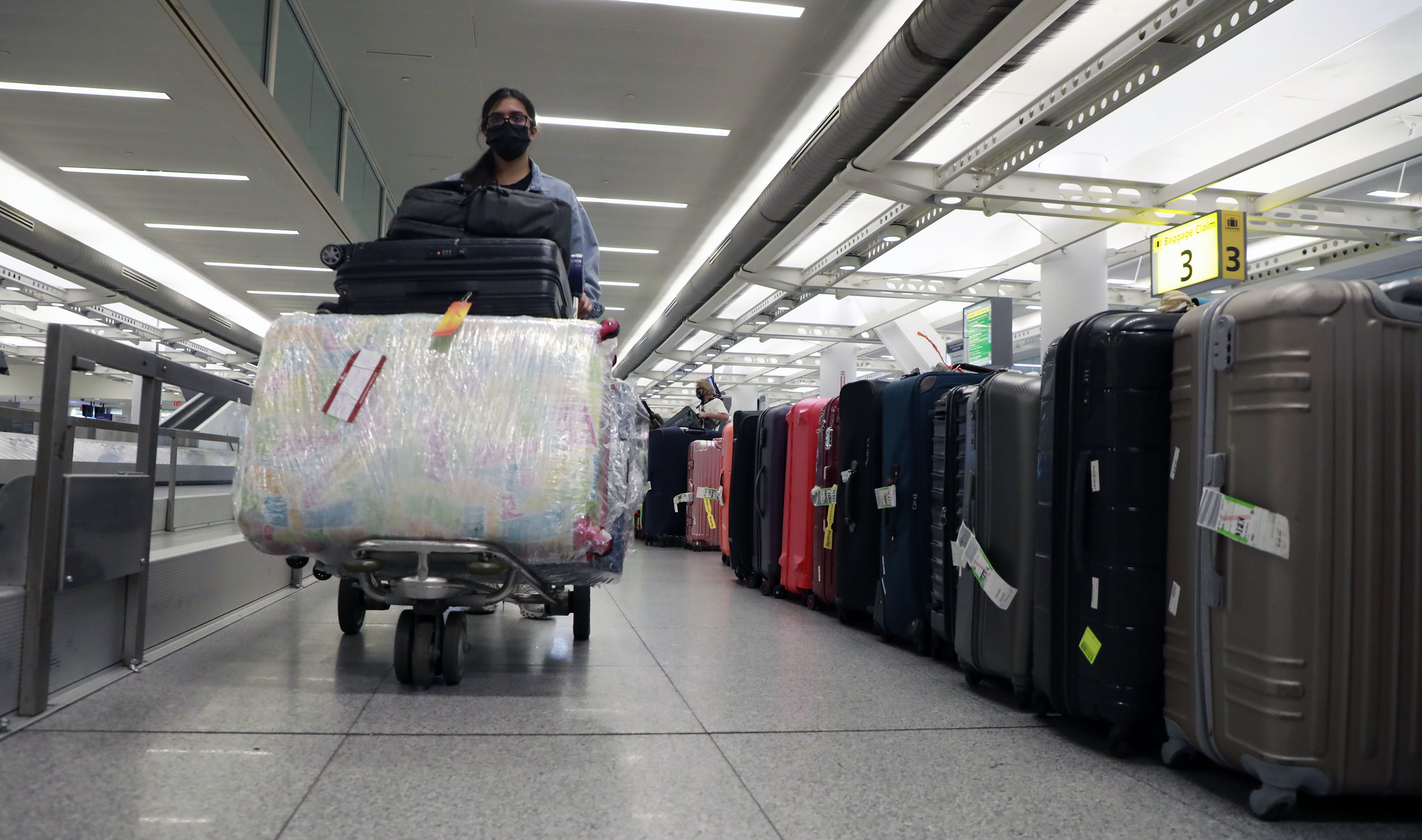 A person walks with luggage in John F. Kennedy International Airport in New York City.