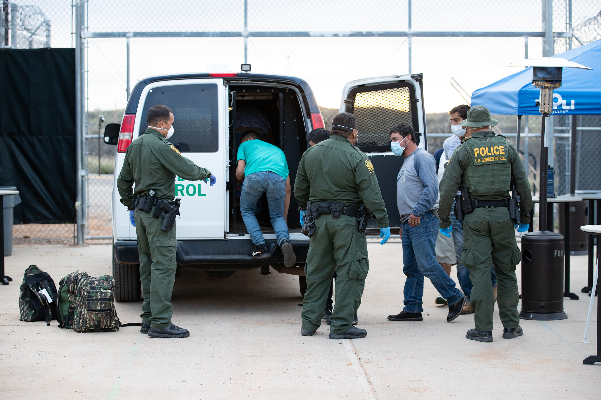 U.S. Border Patrol agents prepare to transport unauthorized migrants to Mexico under Title 42.
