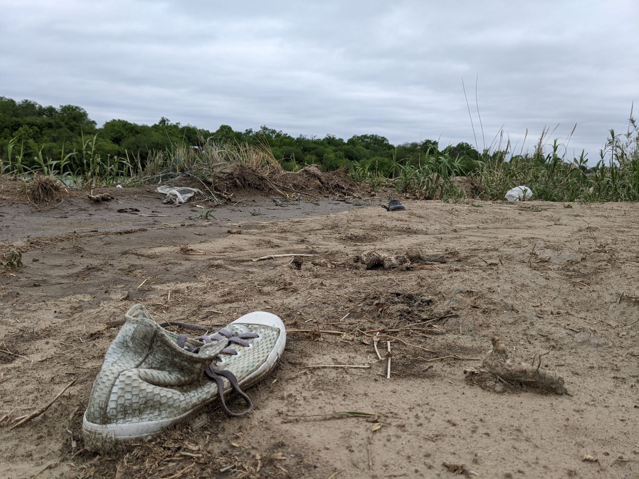 An abandoned shoe lies in the mud along the U.S.-Mexico border.