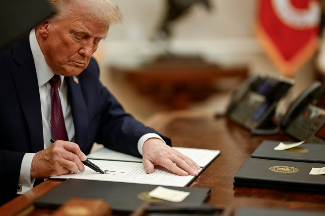 President Donald Trump signs an executive action
