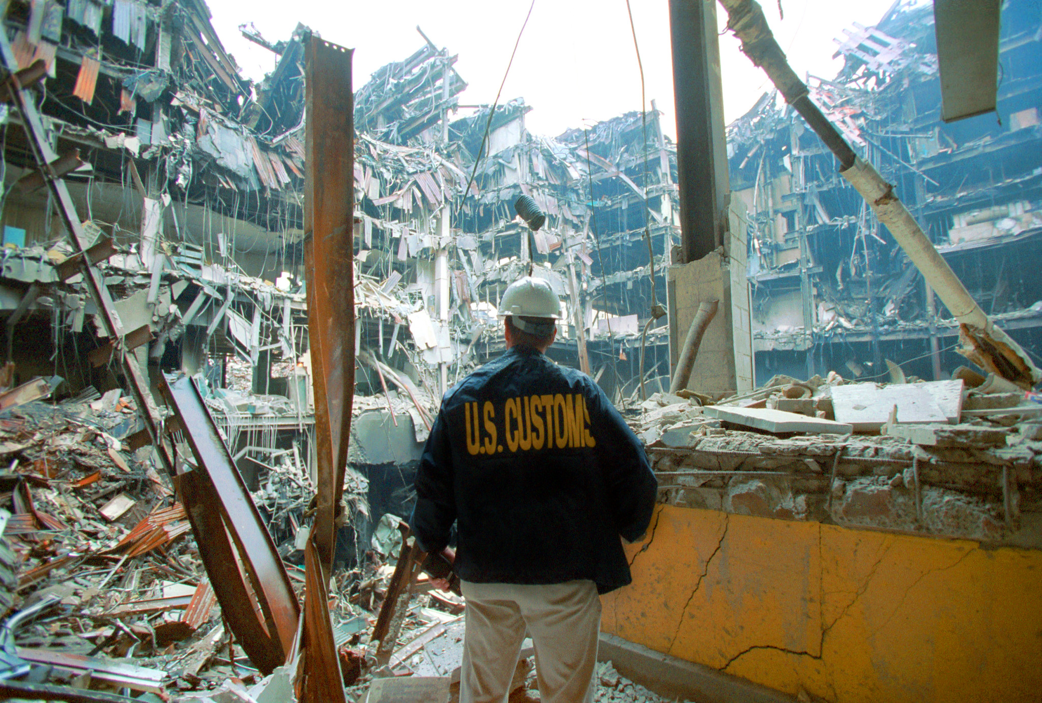 A U.S. Customs agent looks at wreckage following the 9/11 terror attacks