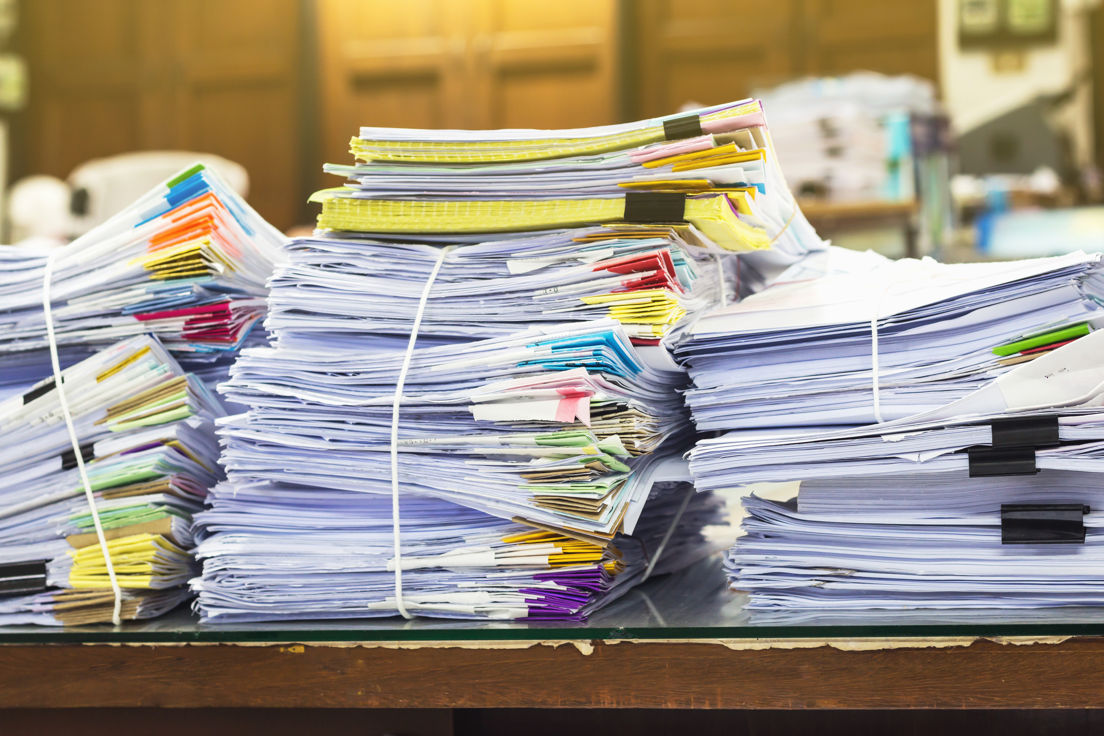 A pile of documents on a desk.