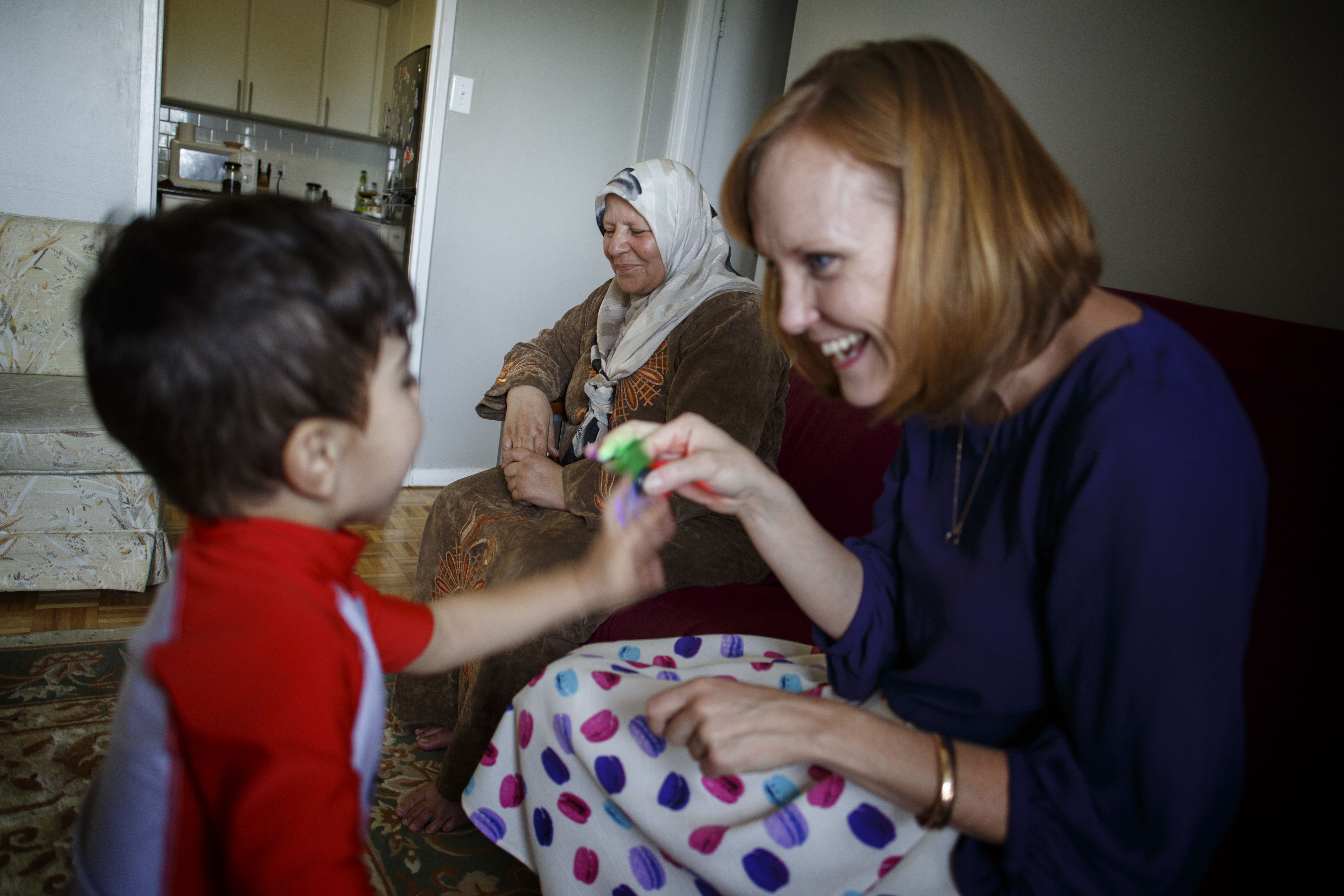 A private refugee sponsor in Canada plays with a boy.