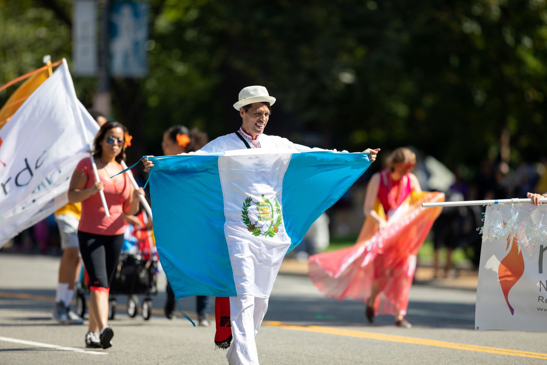 A man carrying the flag of Guatemala in a parade in Washington, DC.