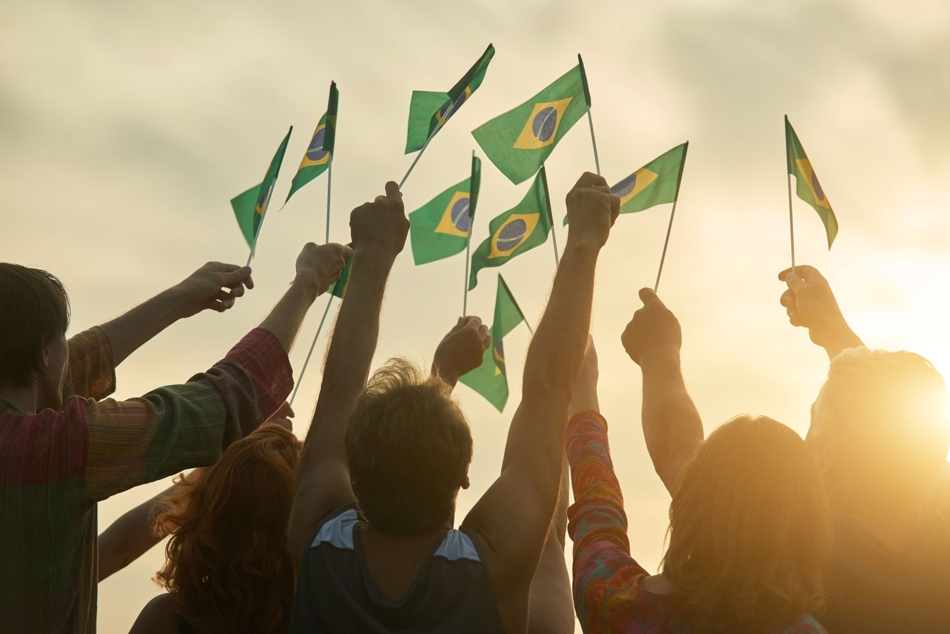 People hold Brazilian flags