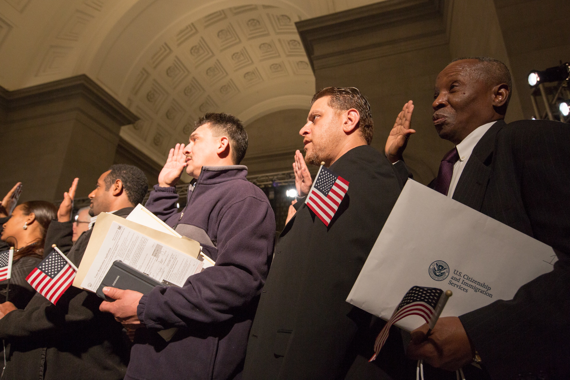 New U.S. citizens take an oath during a naturalization ceremony.