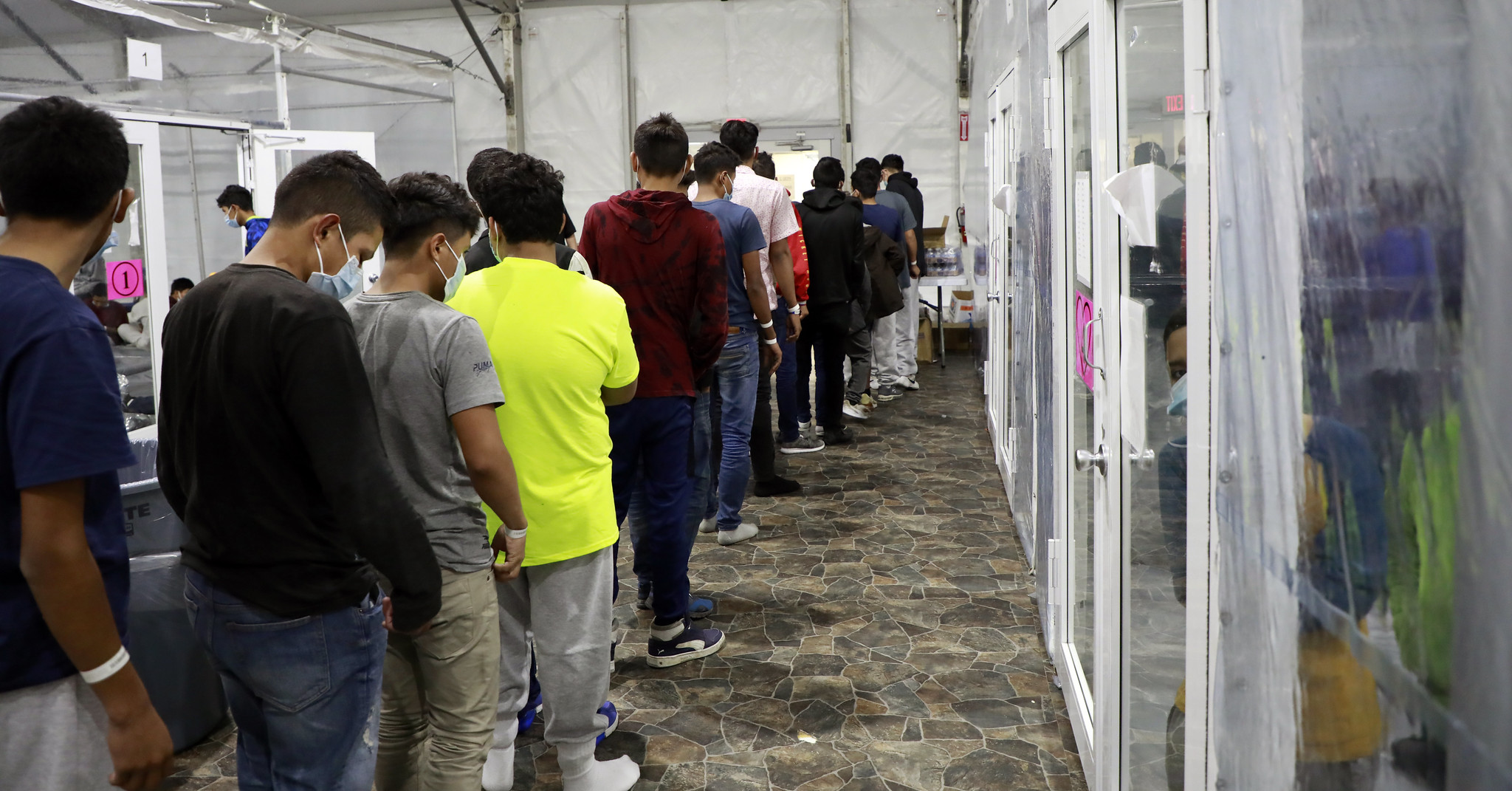 Unaccompanied minors undergo processing at a temporary facility in Texas.